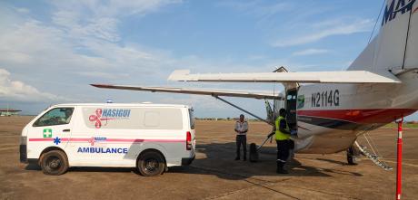 Pastor Simon transferred from the MAF plane to the ambulance for the hospital